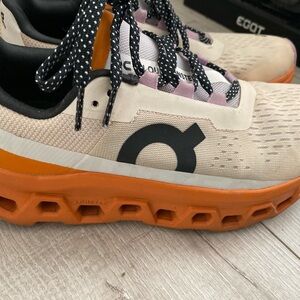 On cloud athletic shoes cream and orange